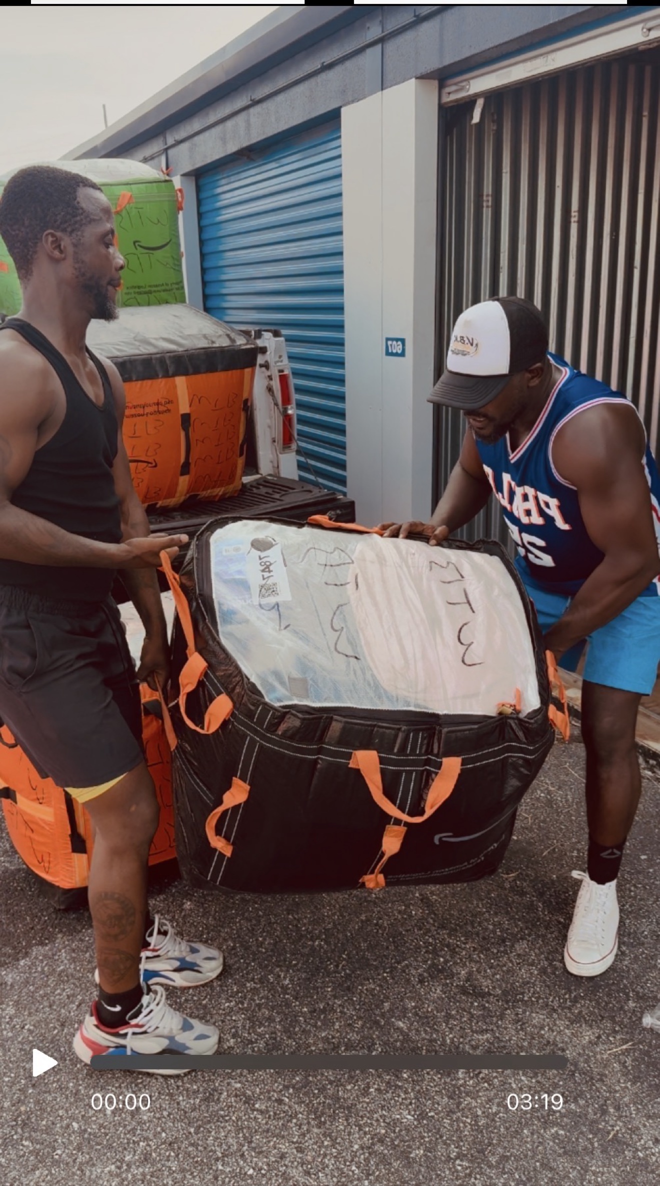 KC and CEO Abraham A. Manobah handling a packed Amazon bag